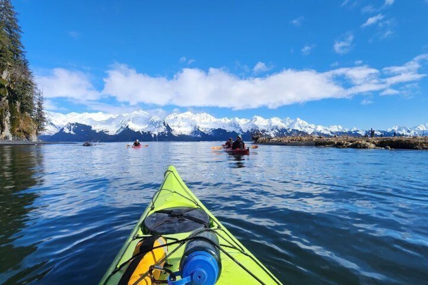 A kayak on calm water with mountains in the background. 5