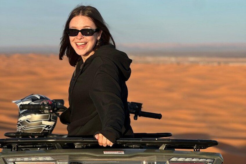 A person on a quad bike in a desert landscape. 3