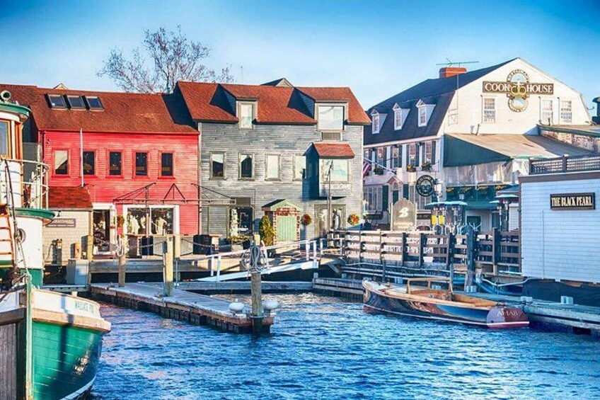 Boats and various shops located at the harbor in Newport Rhode Island in the setting sun 1