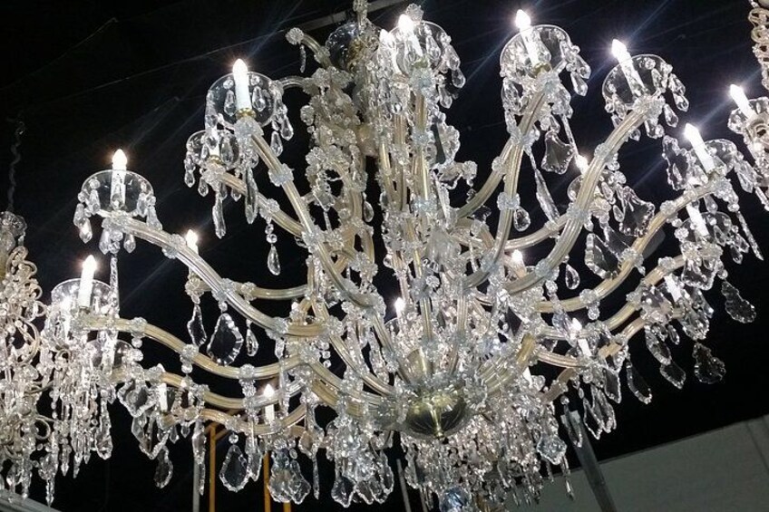 A large, ornate crystal chandelier with multiple arms and hanging crystals. 4