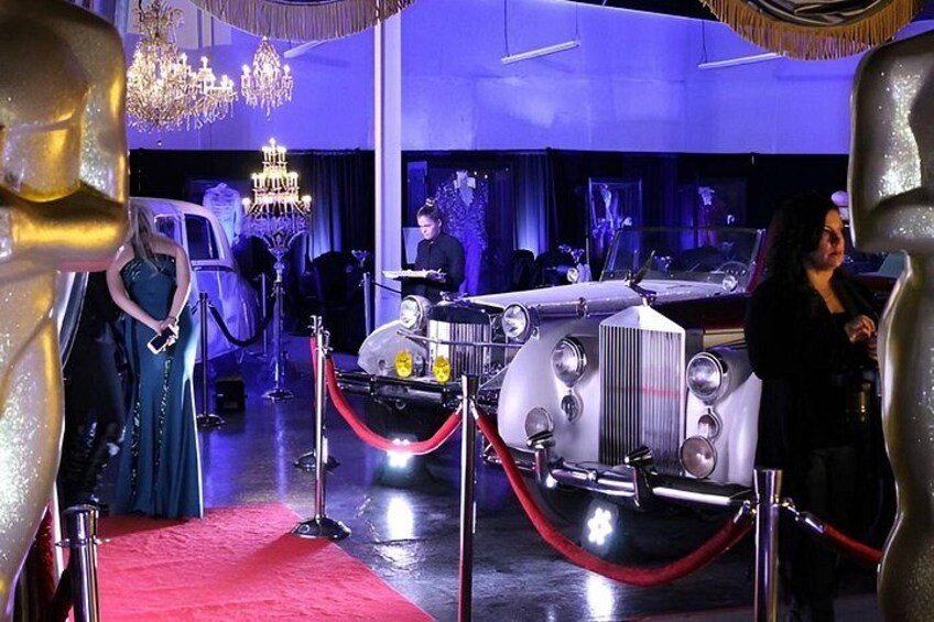 A red carpet event with a vintage car and a chandelier. 3