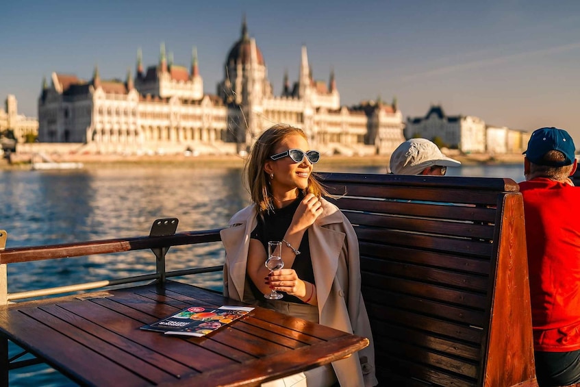 A person on a boat with a cityscape in the background. 5