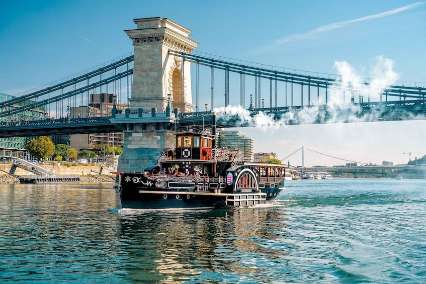 A steamboat with passengers on the water, a bridge, and a statue in the background. 2