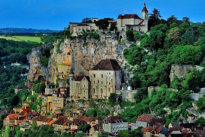 A historic town perched on a cliff, with a prominent church and castle. 1
