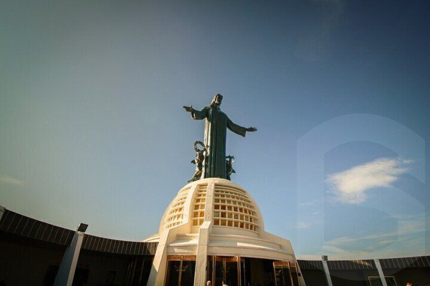 A statue on a dome with a clear sky in the background. 3