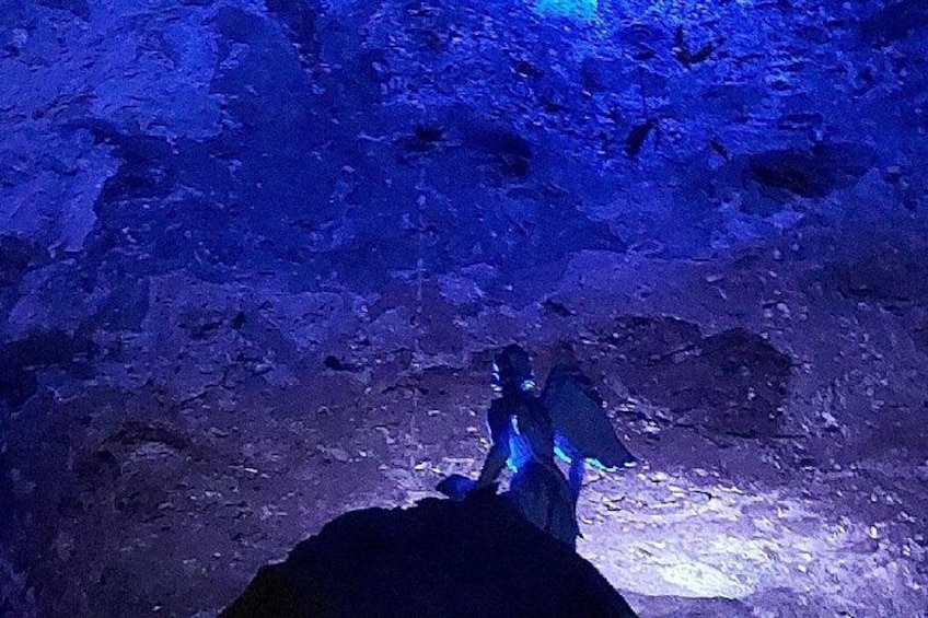 A cave interior with blue lighting and rocky formations. 4