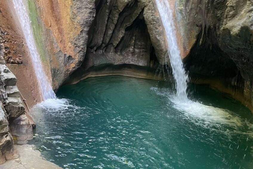A natural waterfall in a cave with clear water. 2