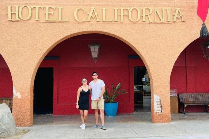 A building with a sign reading 'HOTEL CALIFORNIA' under an arched entrance. 2
