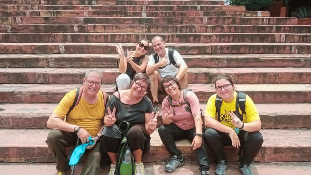 A group of people sitting on wooden steps. 3