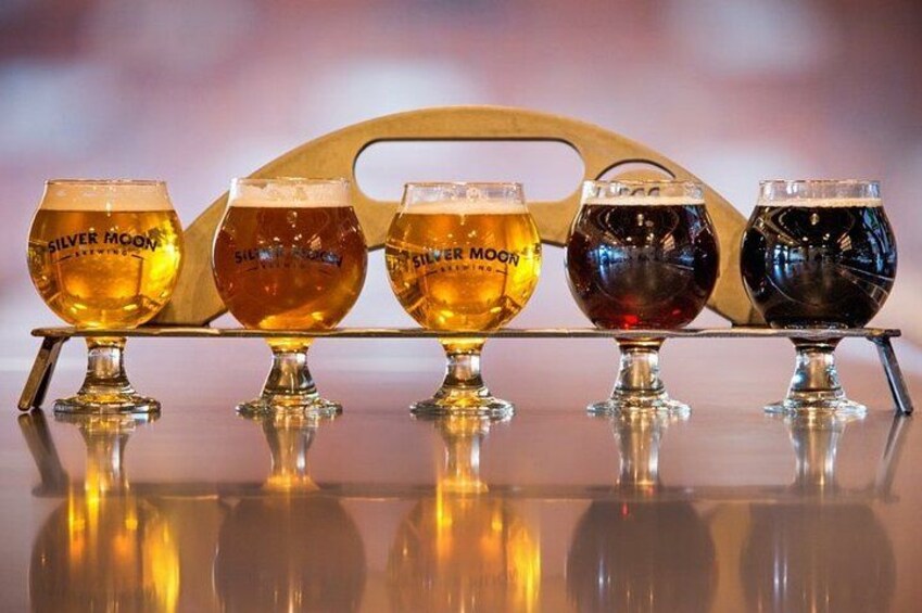 Five glasses of beer on a bar counter. 3