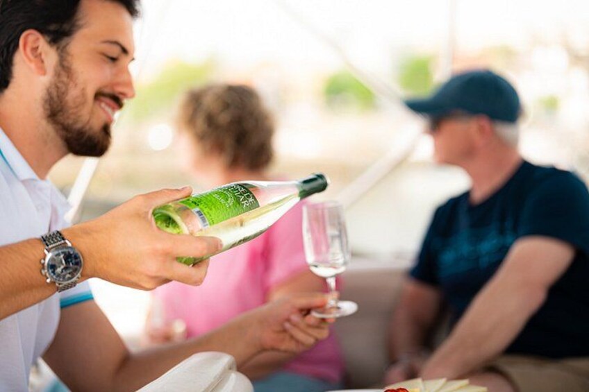 A person pouring a drink into a glass. 4