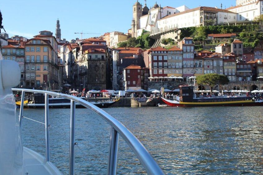 A river with boats, a bridge, and historic buildings along the banks. 2