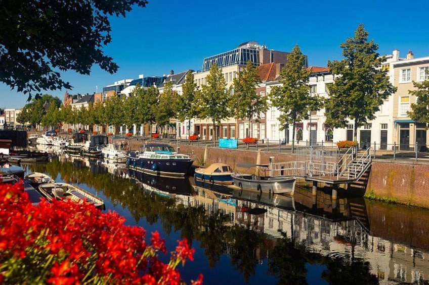 A canal with boats, a bridge, and buildings along the water. 3