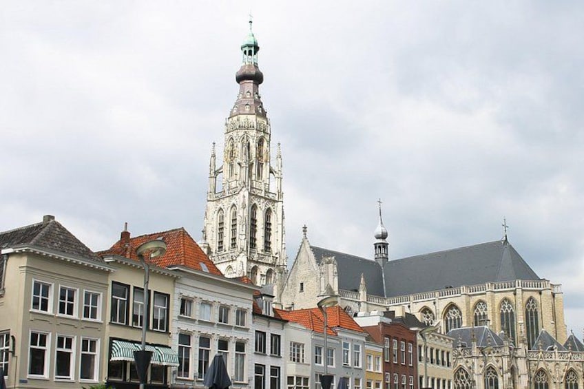 A historic church with a tall spire and adjacent buildings with traditional architecture. 5