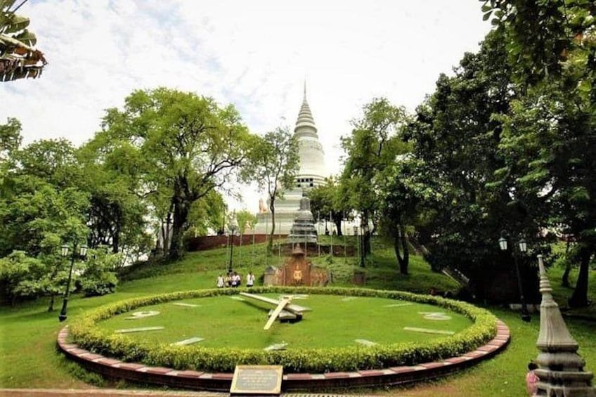 A pagoda surrounded by a circular garden with trees and a clear sky. 3