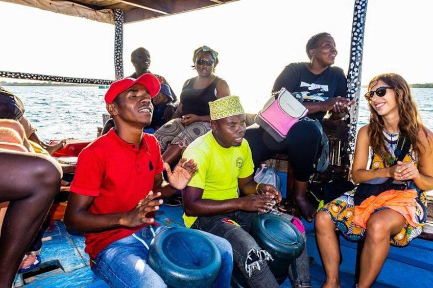 People on a boat, some wearing hats, and one person holding a pink bag. 2