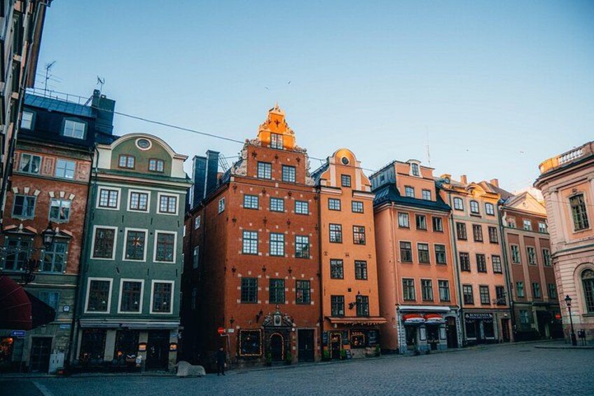 A row of colorful buildings with a prominent orange building in the center. 1