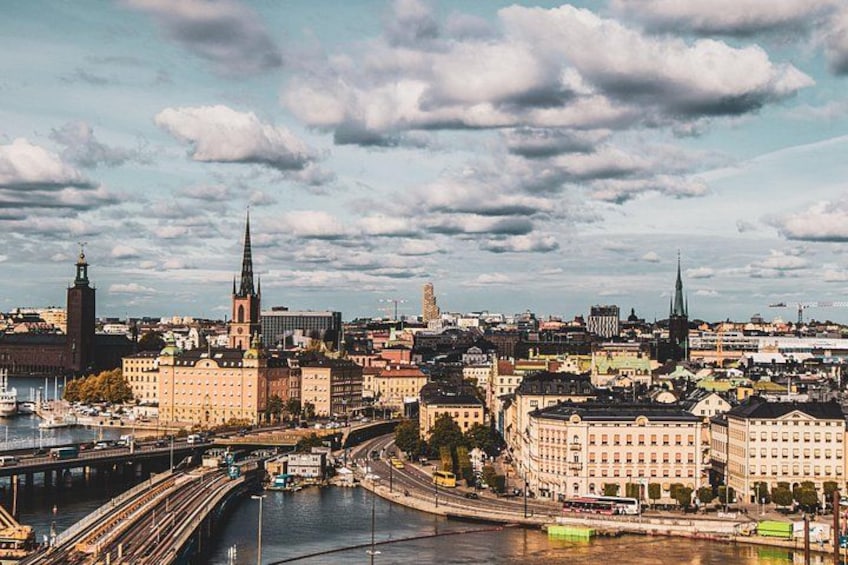 A cityscape with a river, bridges, and prominent buildings including a church with a tall spire. 5