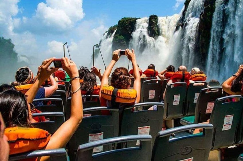 People on a boat watching a waterfall. 2