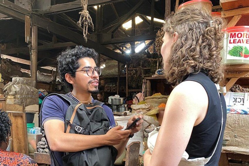 A person with a backpack in a rustic indoor setting with wooden beams and various items on shelves. 3