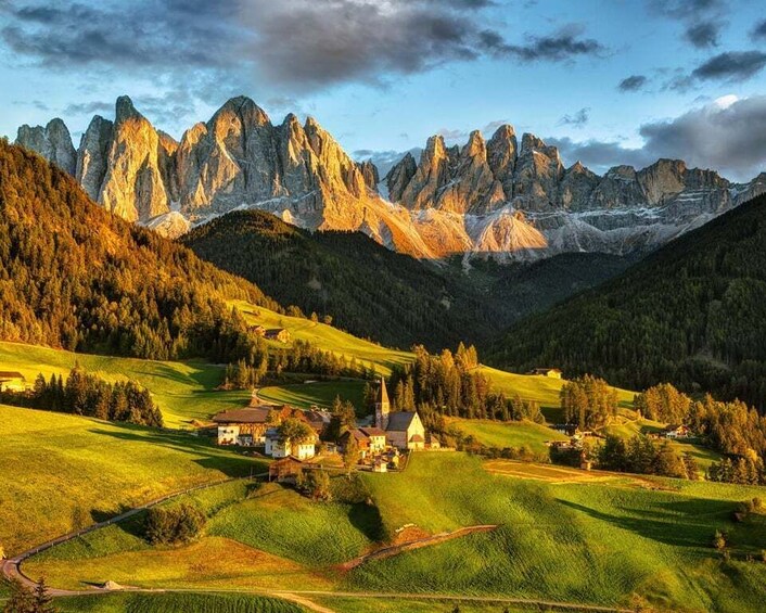 A mountainous landscape with a village nestled in the valley. 1