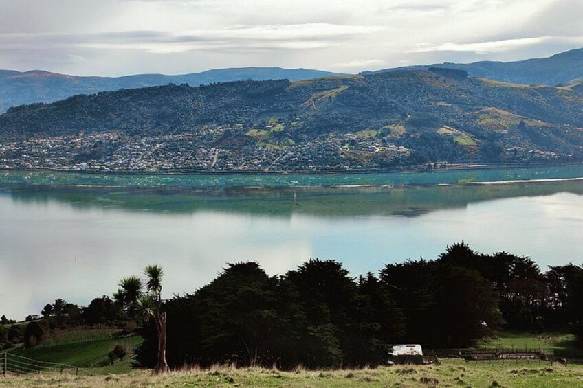 A lake with a town in the background, surrounded by hills. 2