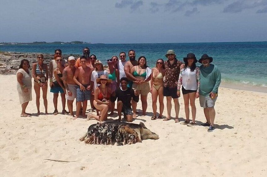 A group of people on a sandy beach with the ocean in the background. 3