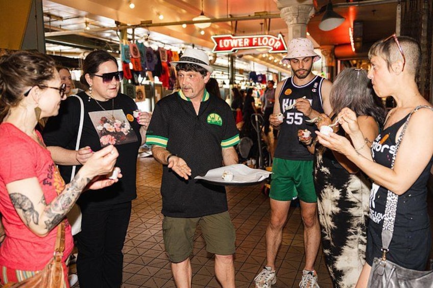 People standing in a market with a sign that reads 'LOWER FLOOR.' 2