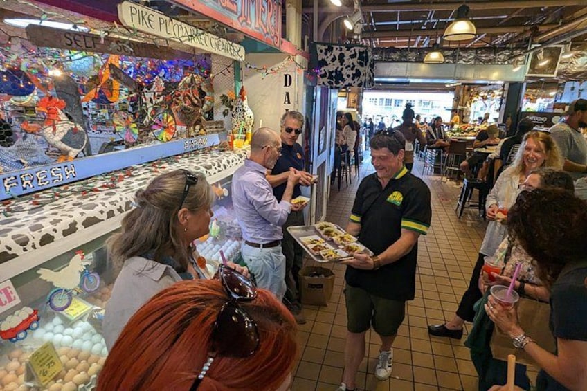 A busy indoor market with people shopping and interacting. 1