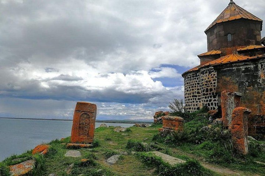 Un sitio histórico costero con ruinas, una torre y un gran monumento de piedra. 2