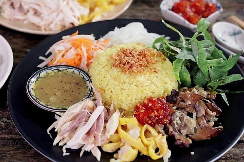A plate of food with rice, vegetables, and meat. 2