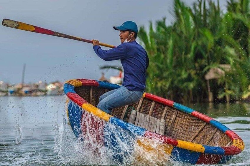 A person rowing a colorful boat on water. 2