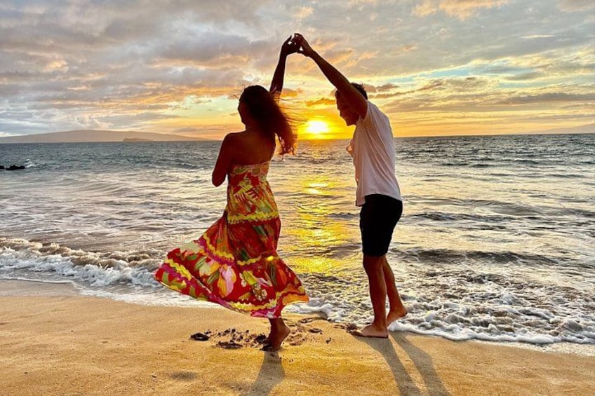 A couple dancing on a beach at sunset. 5
