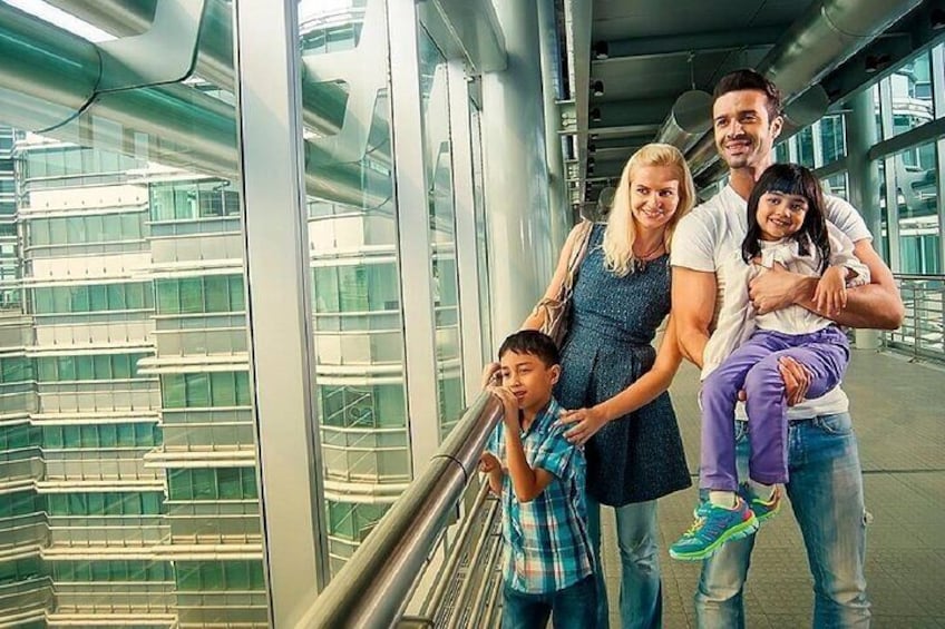 A family of four in an airport terminal with glass walls and a modern design. 5