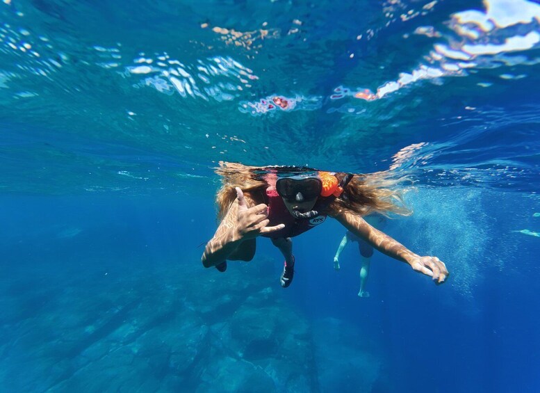 A person snorkeling underwater. 2