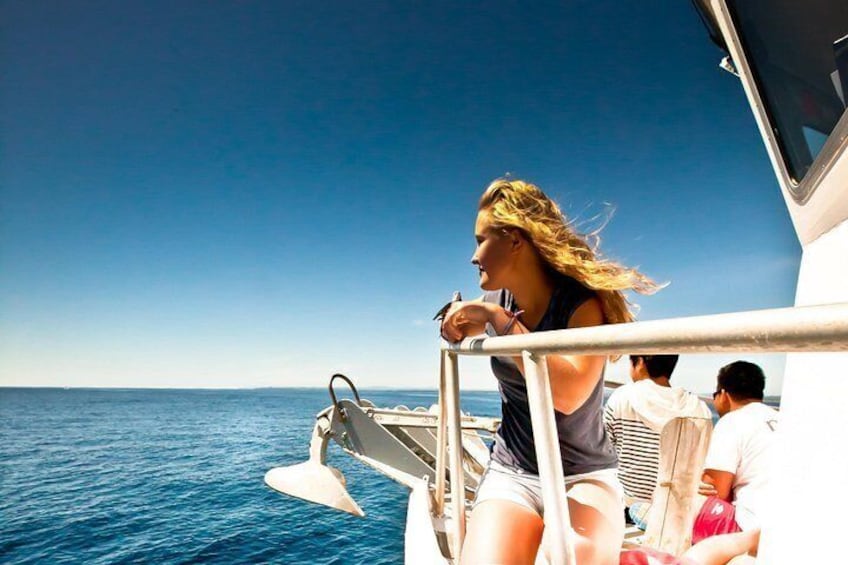 A person on a boat with a clear view of the ocean. 5