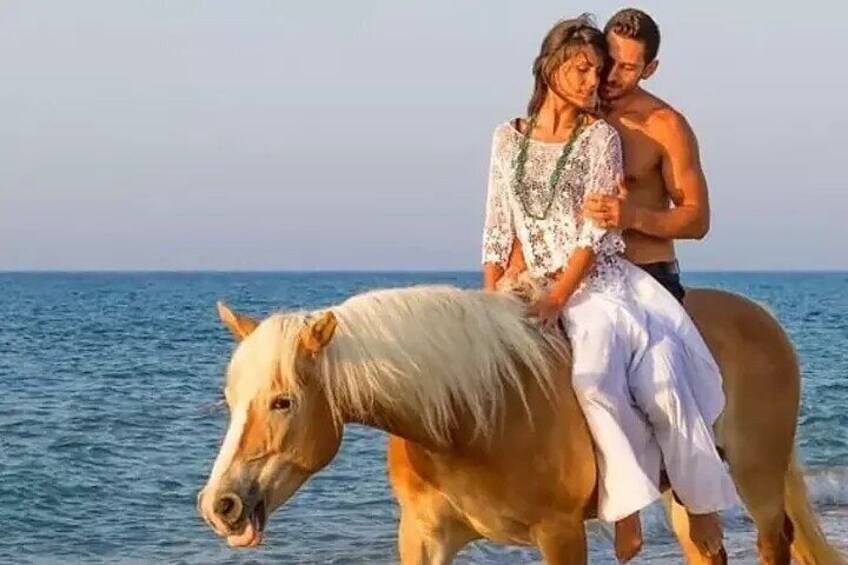 A person riding a horse near a body of water. 2