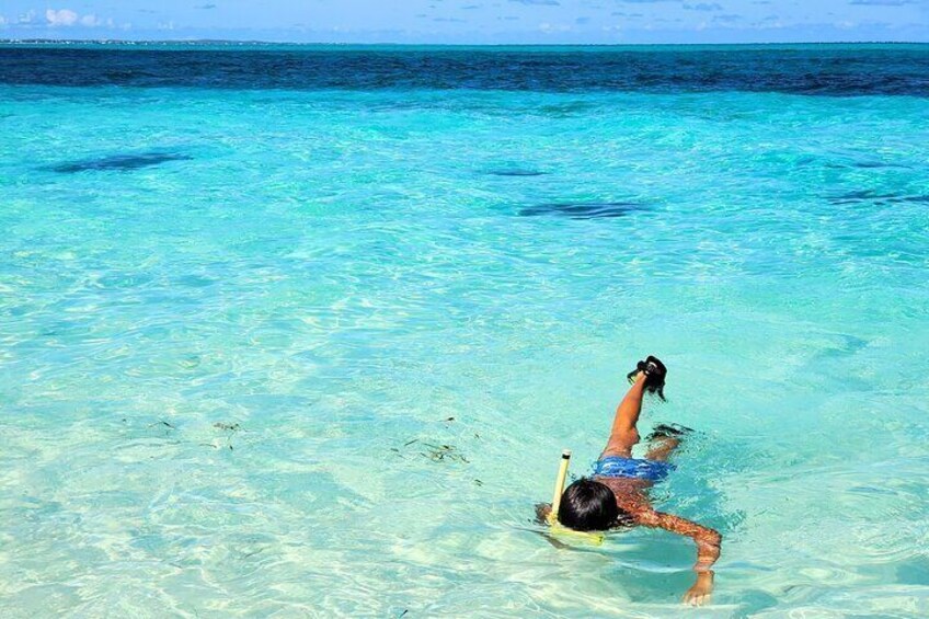 A person snorkeling in clear turquoise water. 1