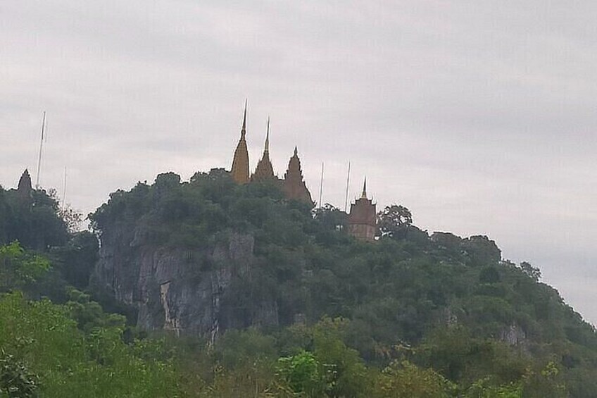 A temple complex on a hill with multiple spires and a smaller building. 2