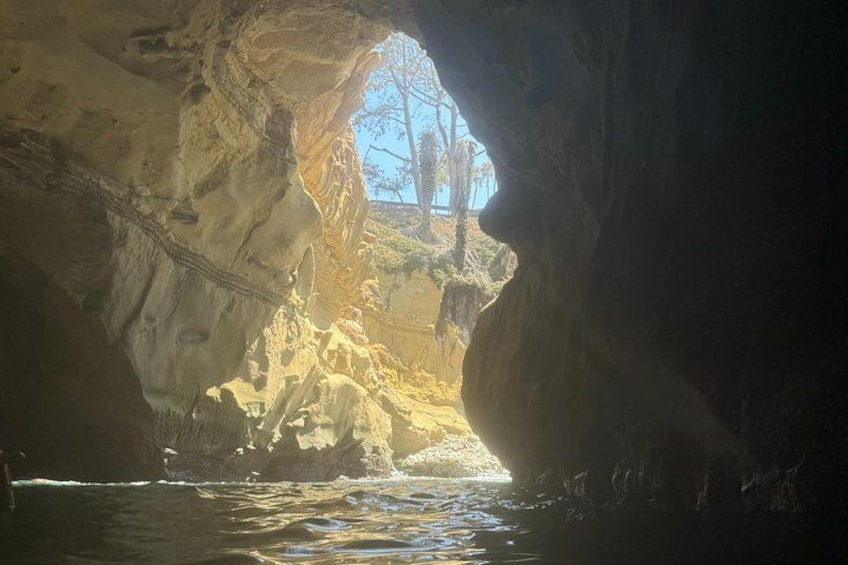 A cave opening with water inside. 5