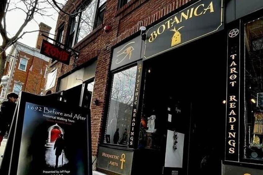 A storefront with a sign reading "BOTANICA" and another sign for "TAROT READINGS". 5
