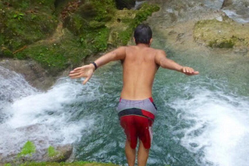 A person standing at the edge of a waterfall. 2