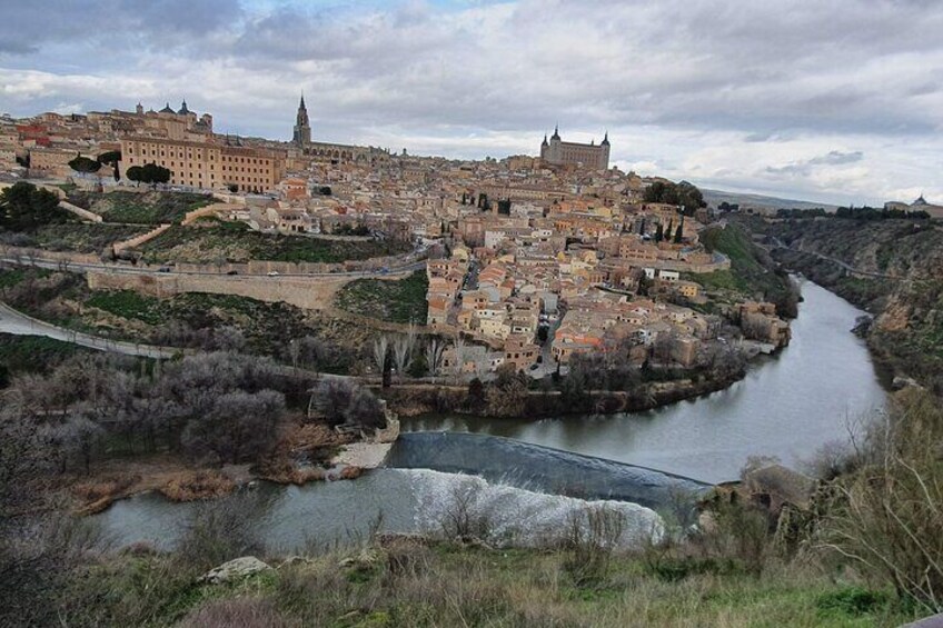 A historic city with a river, a prominent castle, and a bridge. 1