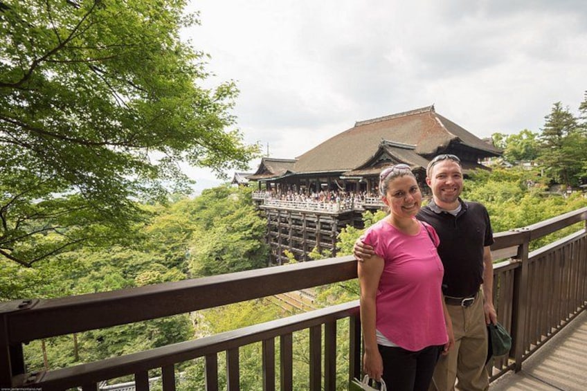 A wooden bridge with a traditional Japanese building in the background. 3