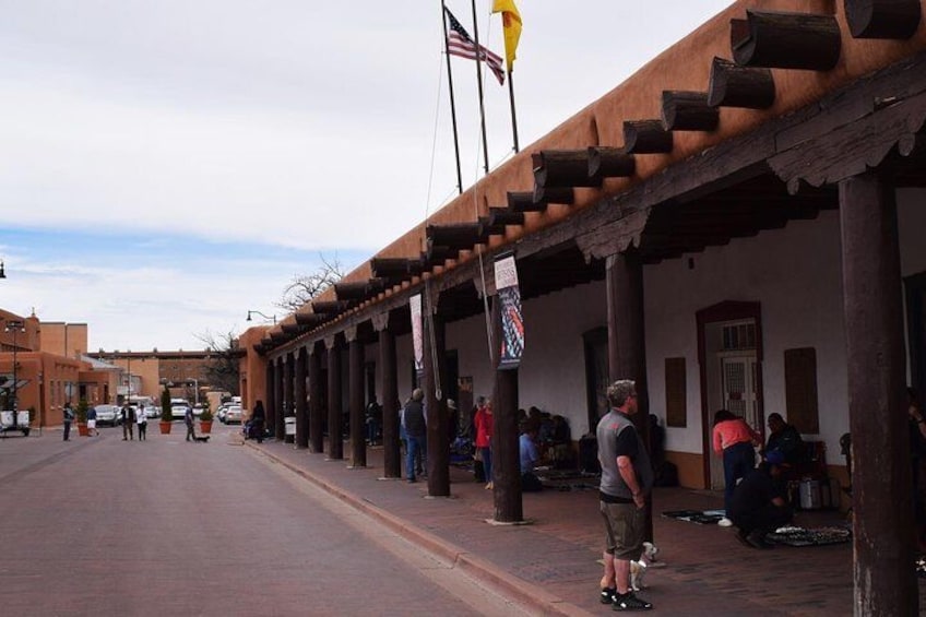 A street with buildings, a flag, and people. 5
