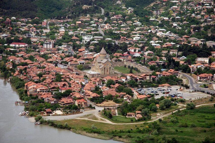 A coastal town with a prominent church, dense residential area, and a river. 2
