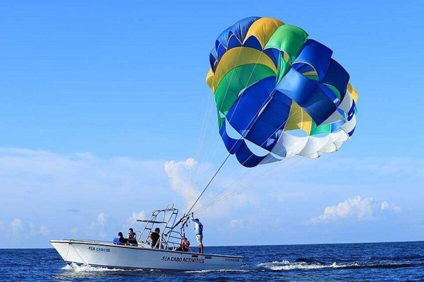A boat with a parasail in the ocean. 2