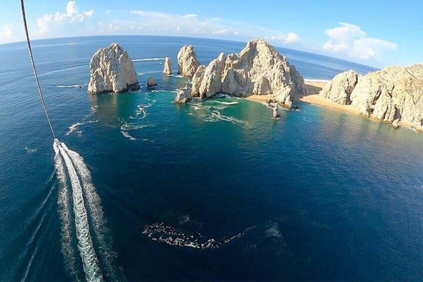 A boat navigating through a coastal area with rocky outcrops and clear blue waters. 1