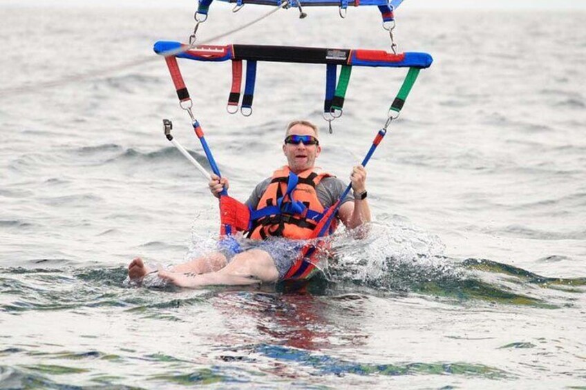 A person water skiing with a tow rope and a life jacket. 5