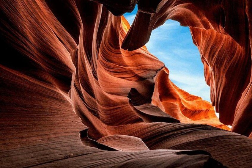 A canyon with red sandstone walls and a clear sky. 4